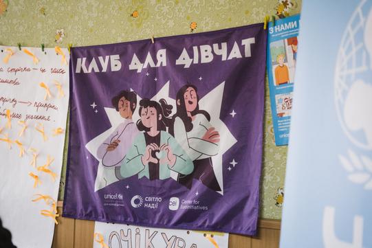Фіолетовий плакат Клубу для дівчат, який працює на Сумщині