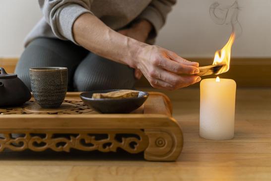 young woman relaxing home with tea candle young woman relaxing home with tea candle